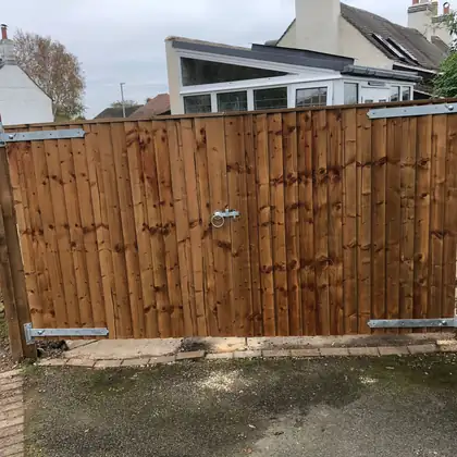 Pair of close-boarded driveway gates on long strap hinges